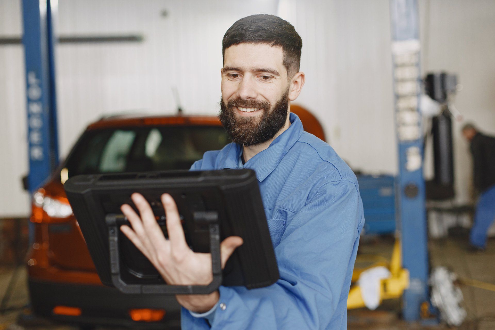 Motolux Technician Inspecting Vehicle